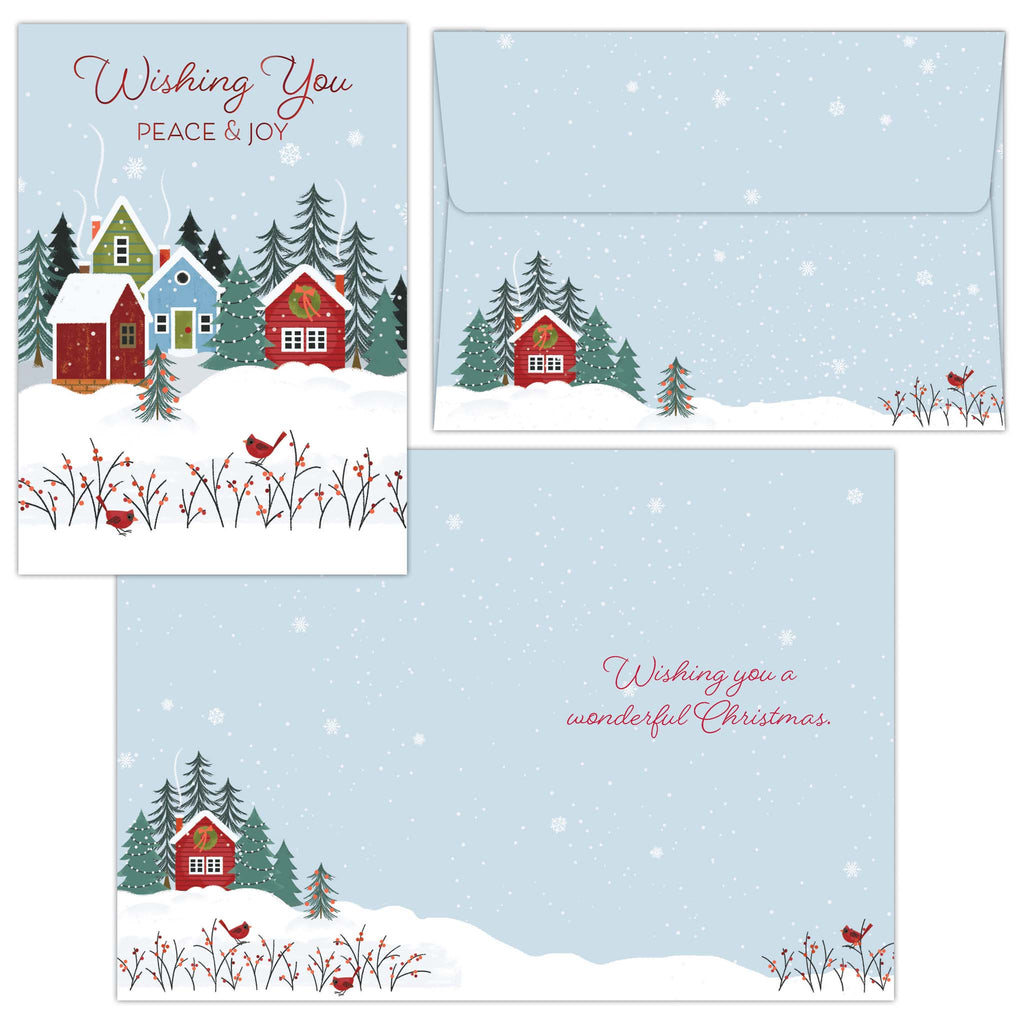 Set of Christmas cards with snowy village scene and envelopes.