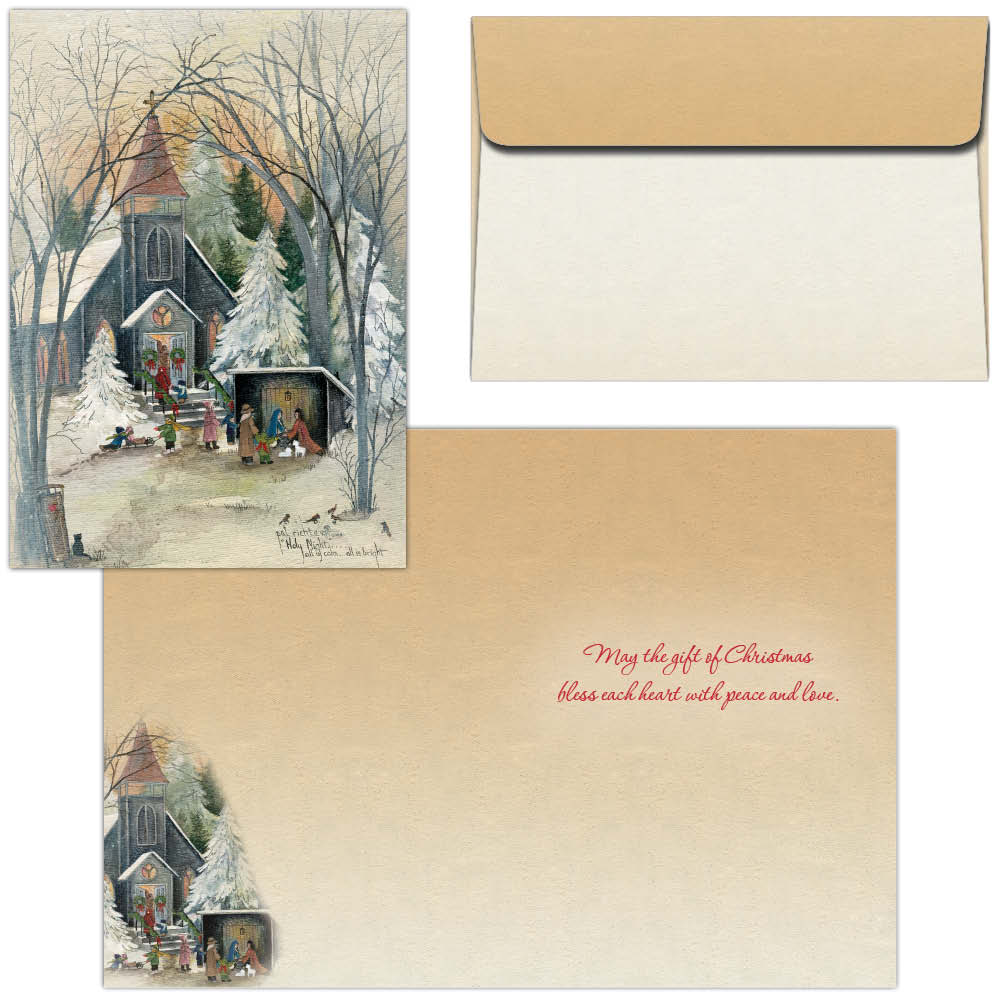 A Christmas greeting card set with a square printed card showing a snowy winter church scene, a kraft paper envelope, and a larger matching card with red cursive text reading 'Merry the gift of Christmas bless each heart with peace and love.'.