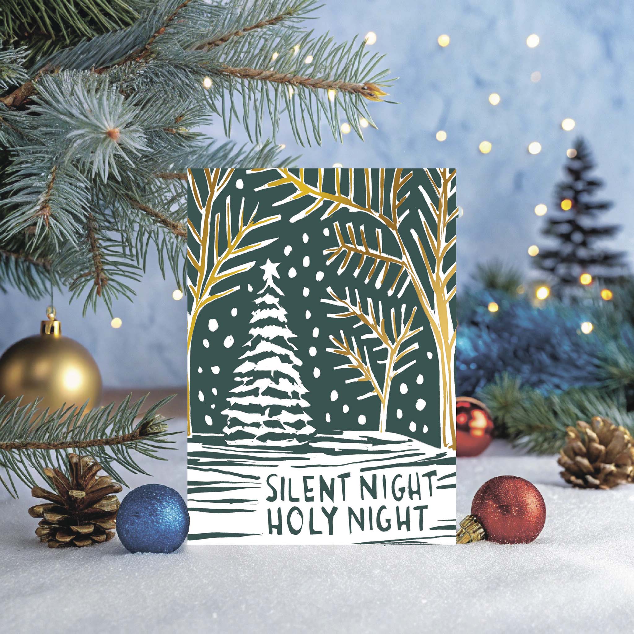 Christmas card with 'Silent Night Holy Night' text and winter scene design, surrounded by festive decorations.