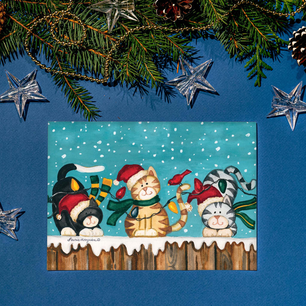 Christmas-themed card with cats and decorations on a blue background