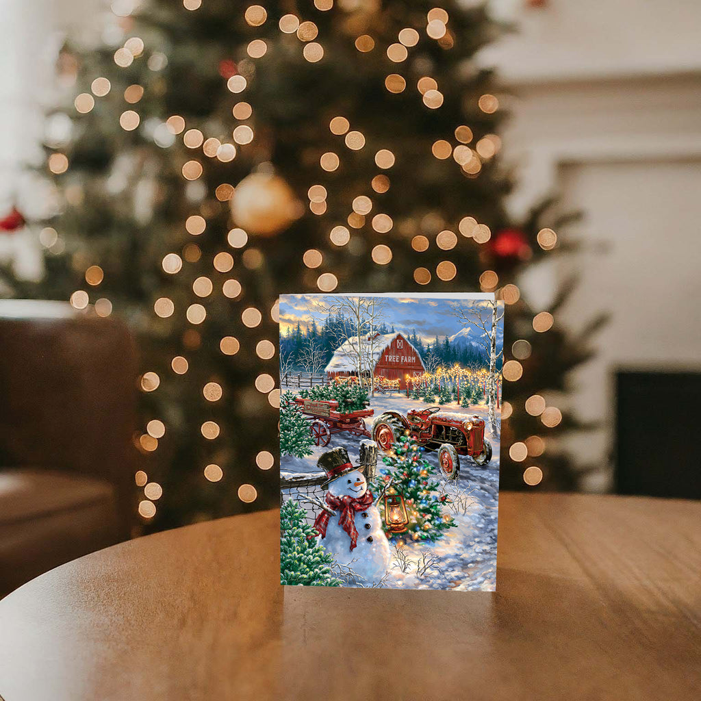 Christmas Tree Farm - 16 Boxed Christmas Cards on a table, with a Christmas tree in the background