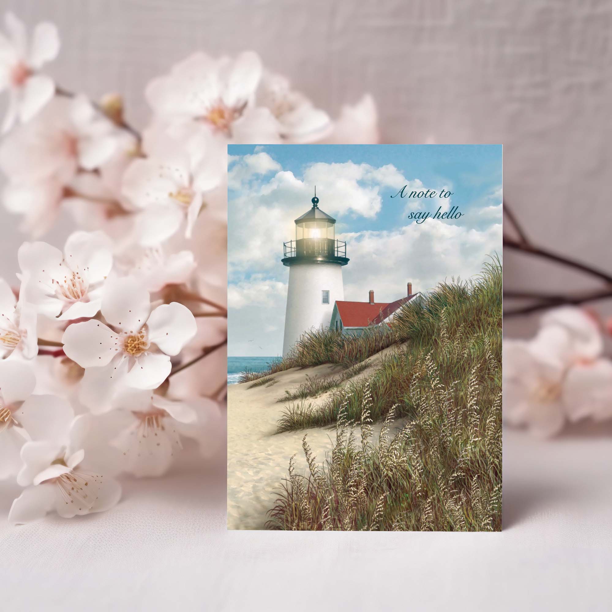 Greeting card with a lighthouse design and cherry blossoms in the background