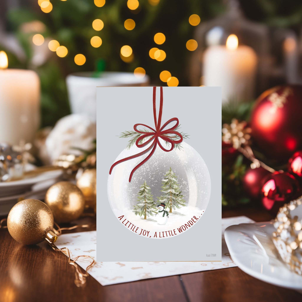 Christmas Snow Globe card on desk with ornaments