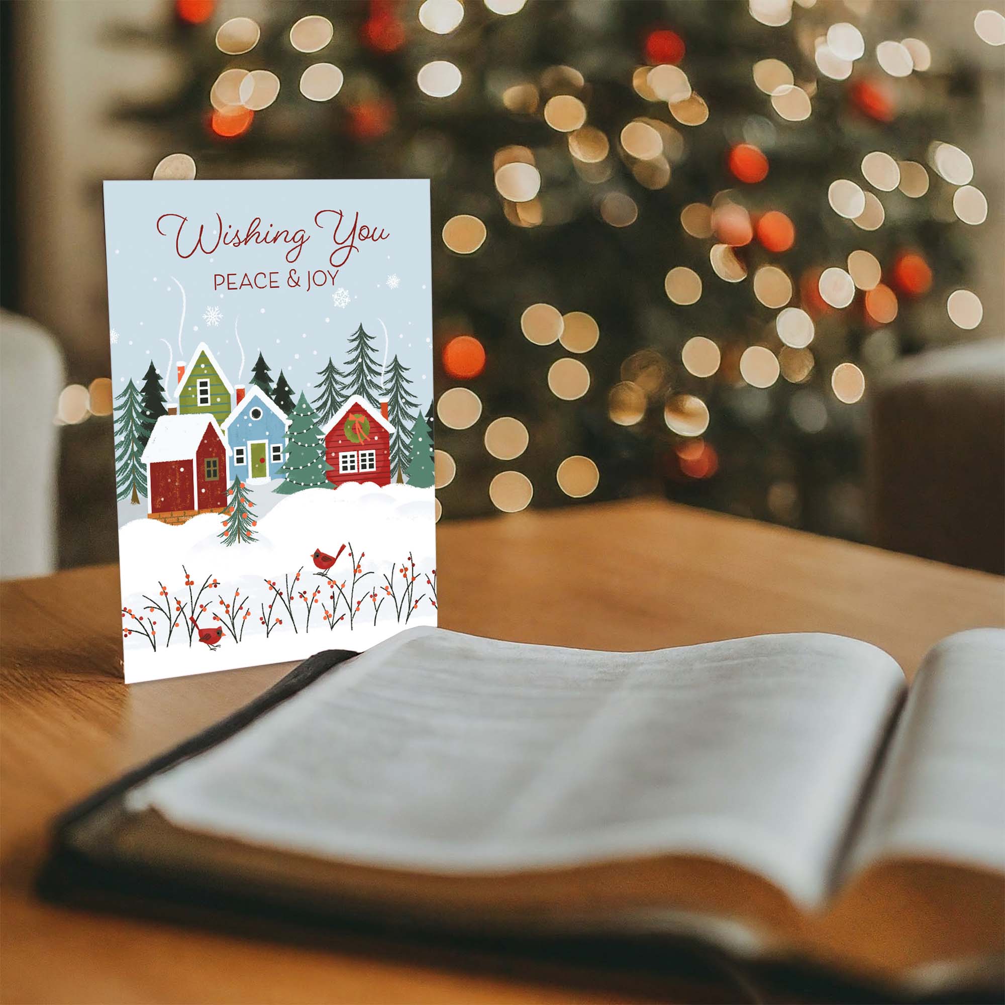 card standing on a table next to an open bible