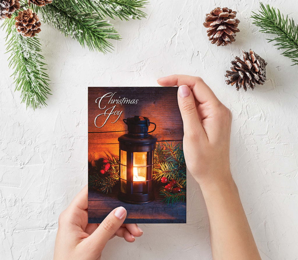 Person Holding Scripture Card with Pinecones