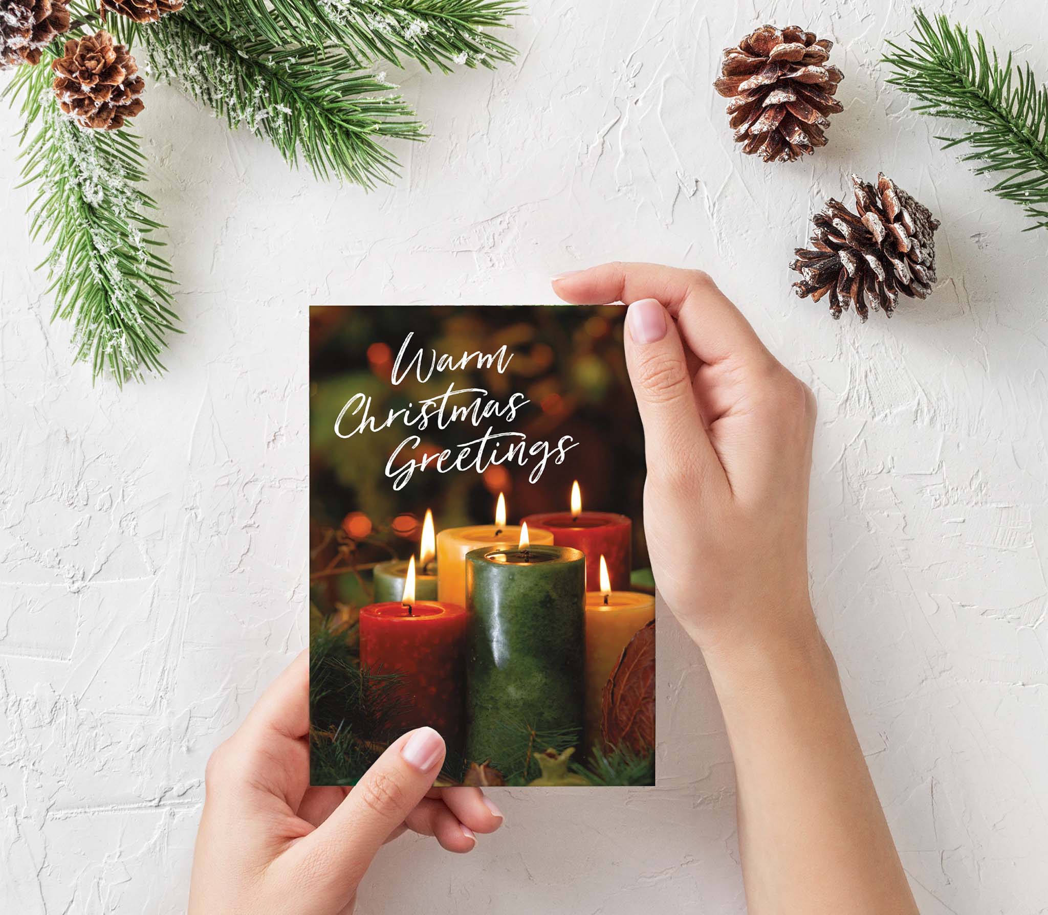 Christian Christmas Card against wall with Pine Cones