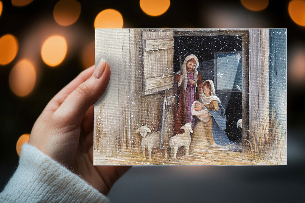 Hand holding Christmas card with Nativity scene