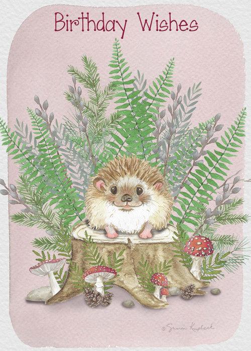 Birthday card with a hedgehog sitting on a mushroom, surrounded by ferns and mushrooms on a pink background.