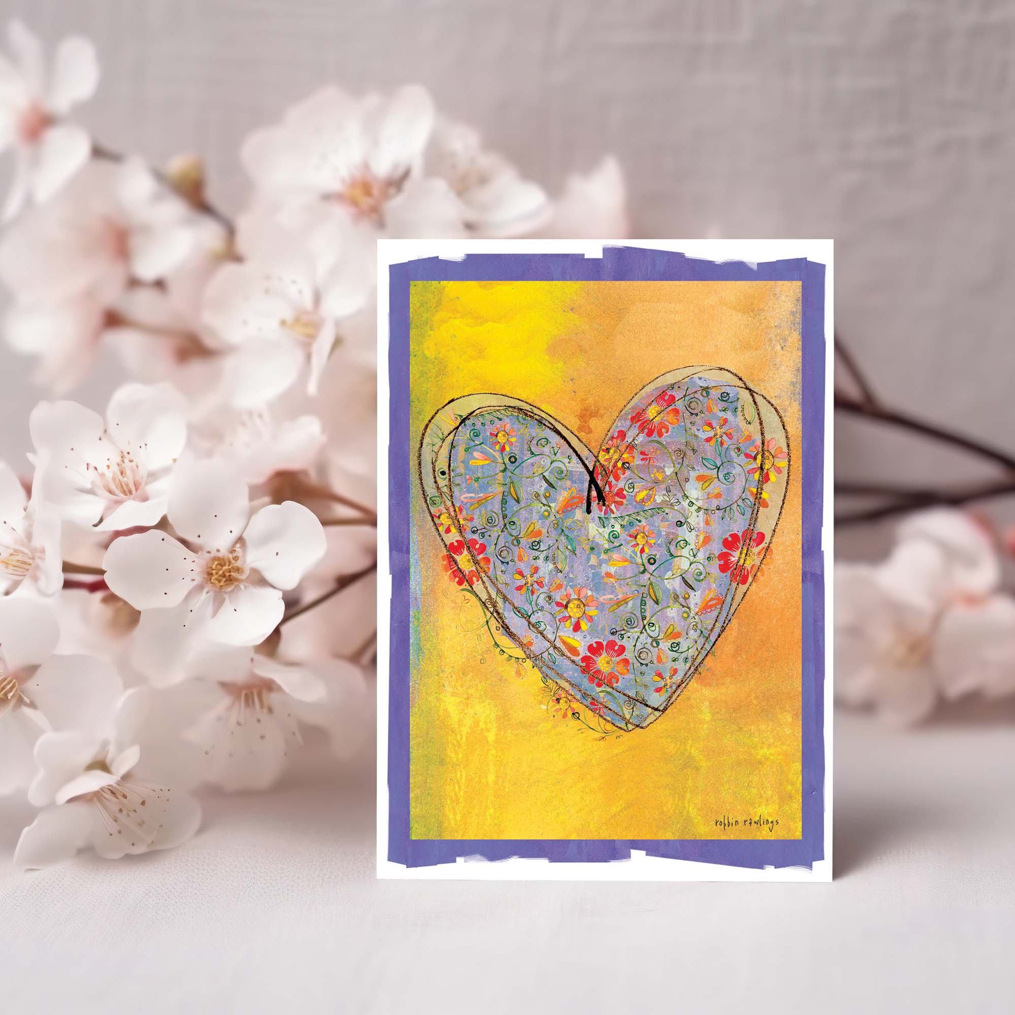 Card with floral heart design on a yellow background, surrounded by white flowers.