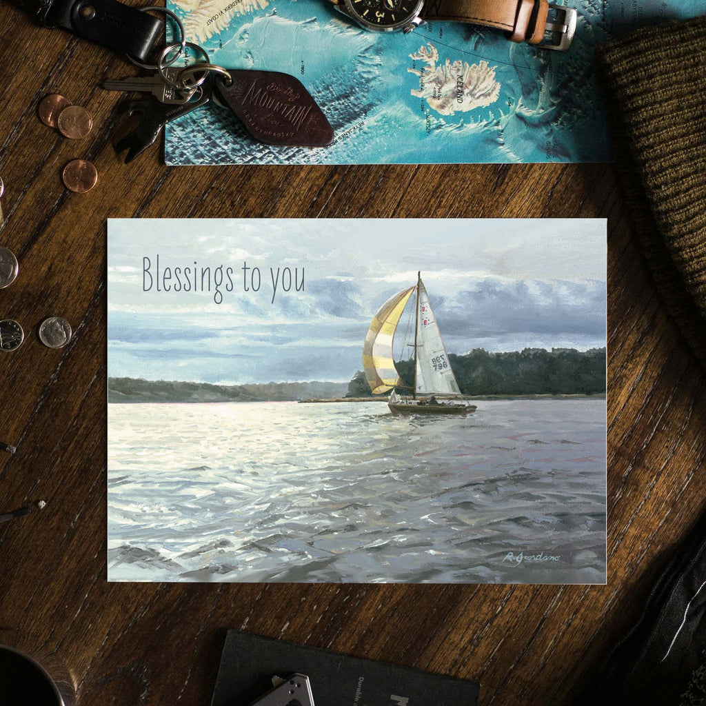 Sailing card with 'Blessings to you' text on a wooden surface with coins and keys.