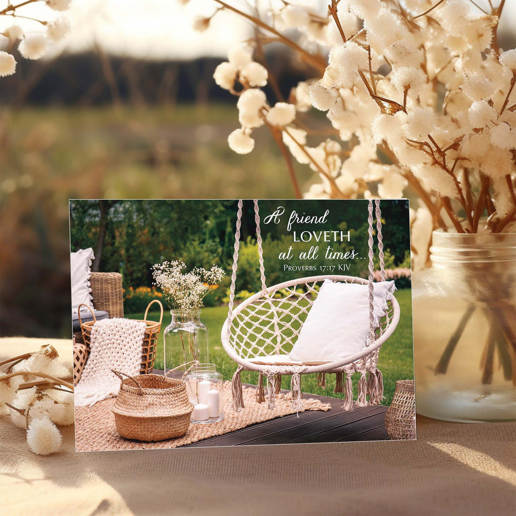 Decorative outdoor setting with a swing, plants, and a motivational quote card.