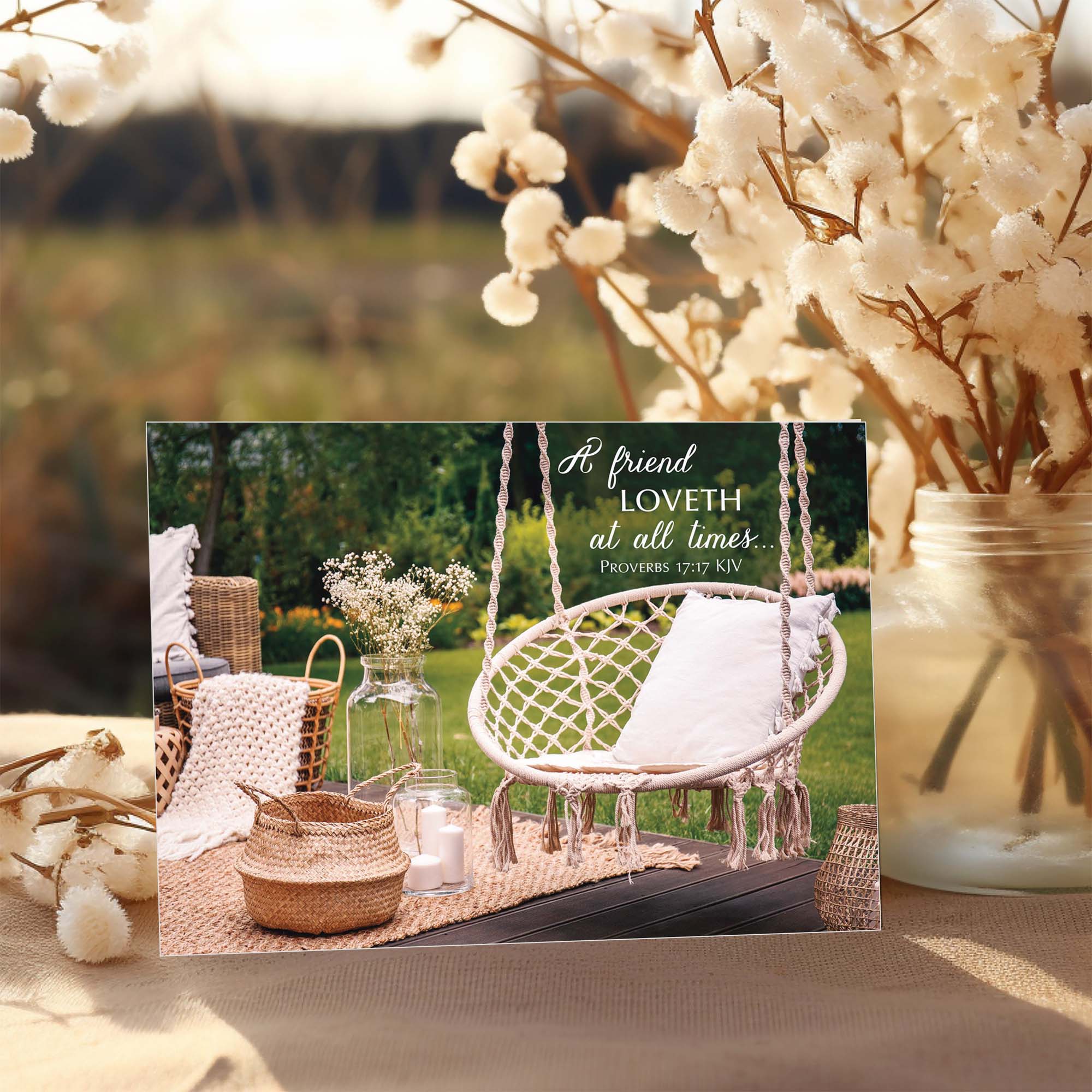 Decorative outdoor setting with a swing, plants, and a motivational quote card.