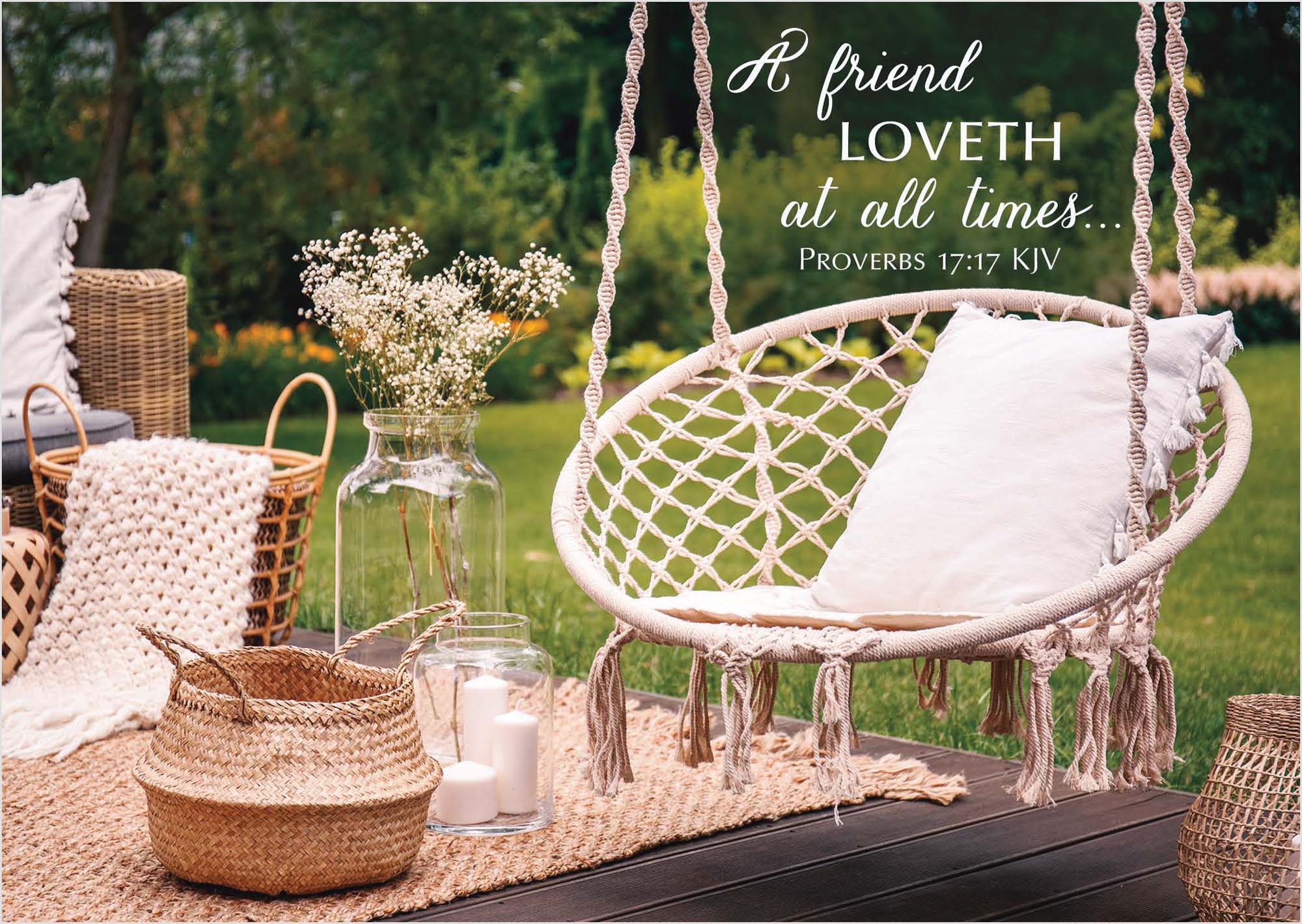 Decorative outdoor swing with candles, flowers, and a quote on a grassy background