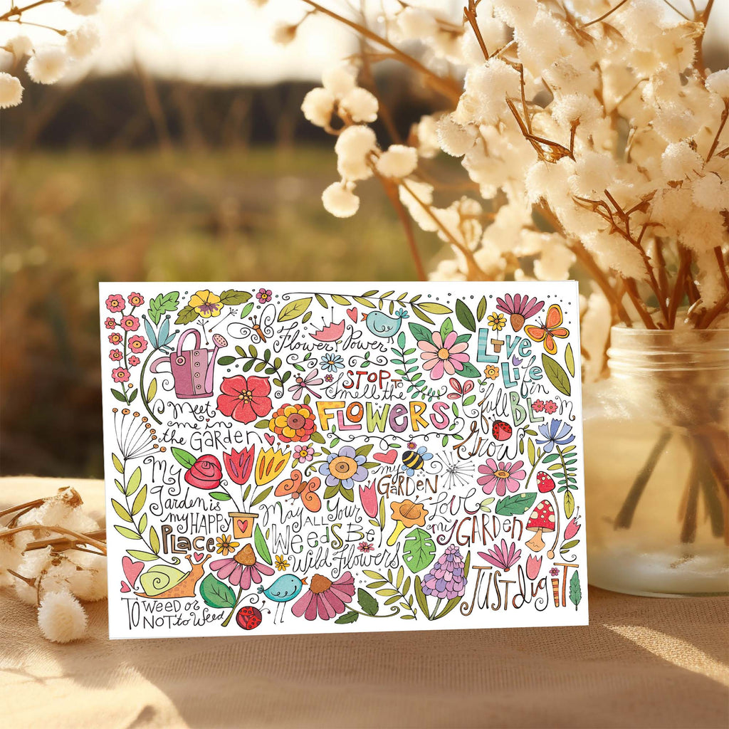 Colorful floral and garden-themed card with decorative text on a blurred natural background.