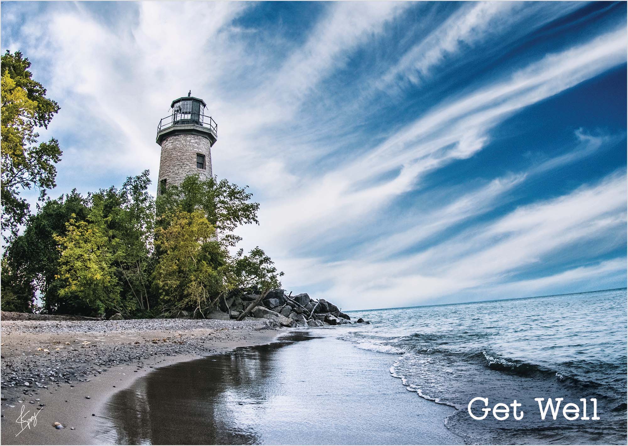 Lighthouse on a beach with a 'Get Well' message