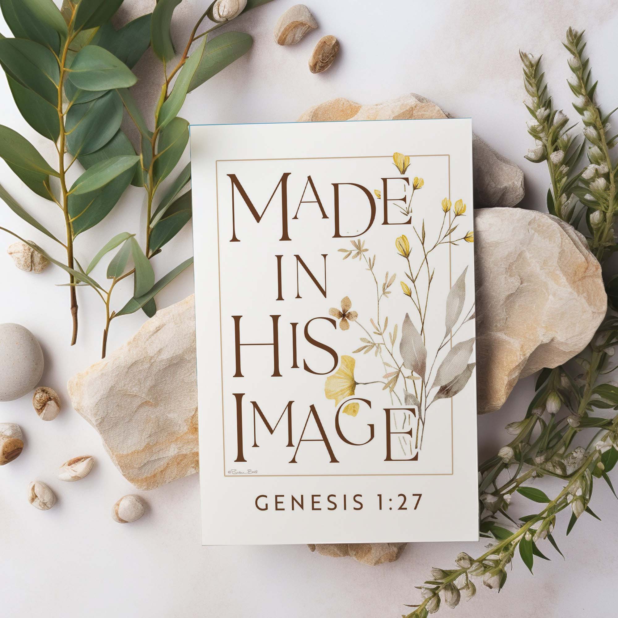 Poster with 'Made in His Image' text surrounded by greenery and stones on a light background