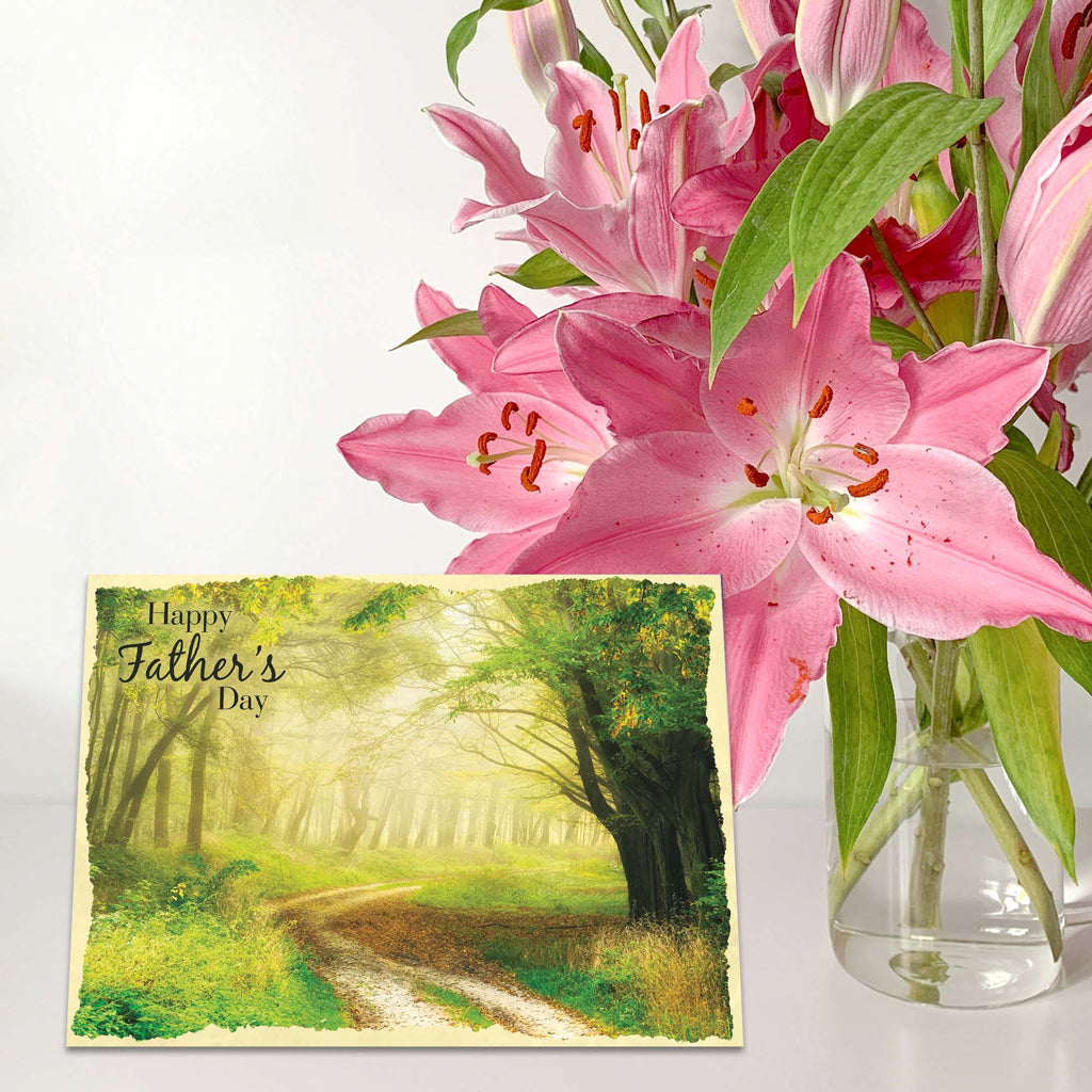 Bouquet of pink lilies with a Father's Day card featuring a forest scene.