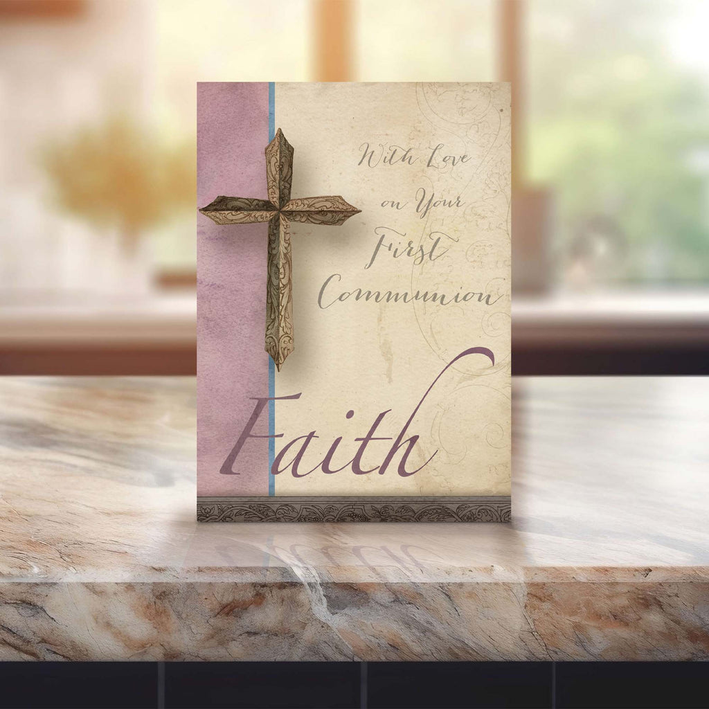 First Communion card with cross design on a marble surface
