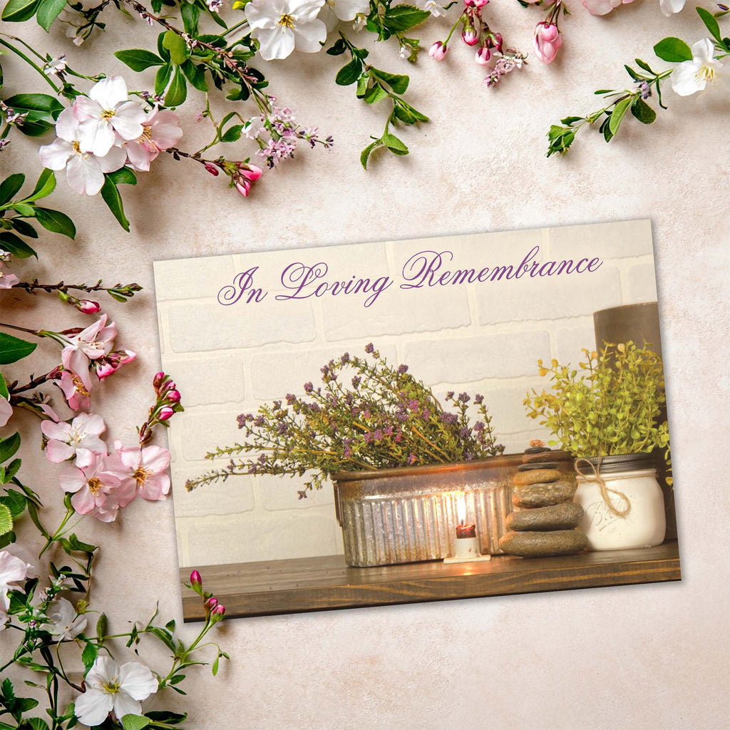 Memorial card with 'In Loving Remembrance' text, candles, and flowers on a light background.