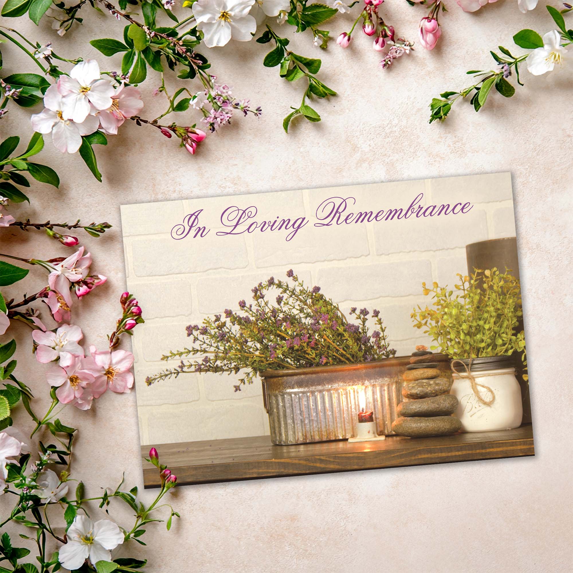 Memorial card with 'In Loving Remembrance' text, candles, and flowers on a light background.