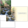 Greeting card with a scenic design of a chapel by a waterfall and a bridge over a stream.