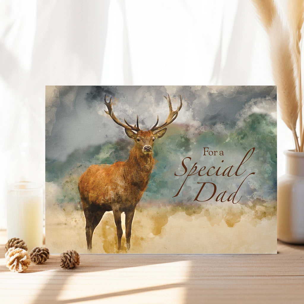 Card with a deer illustration and 'For a Special Dad' text on a scenic background.