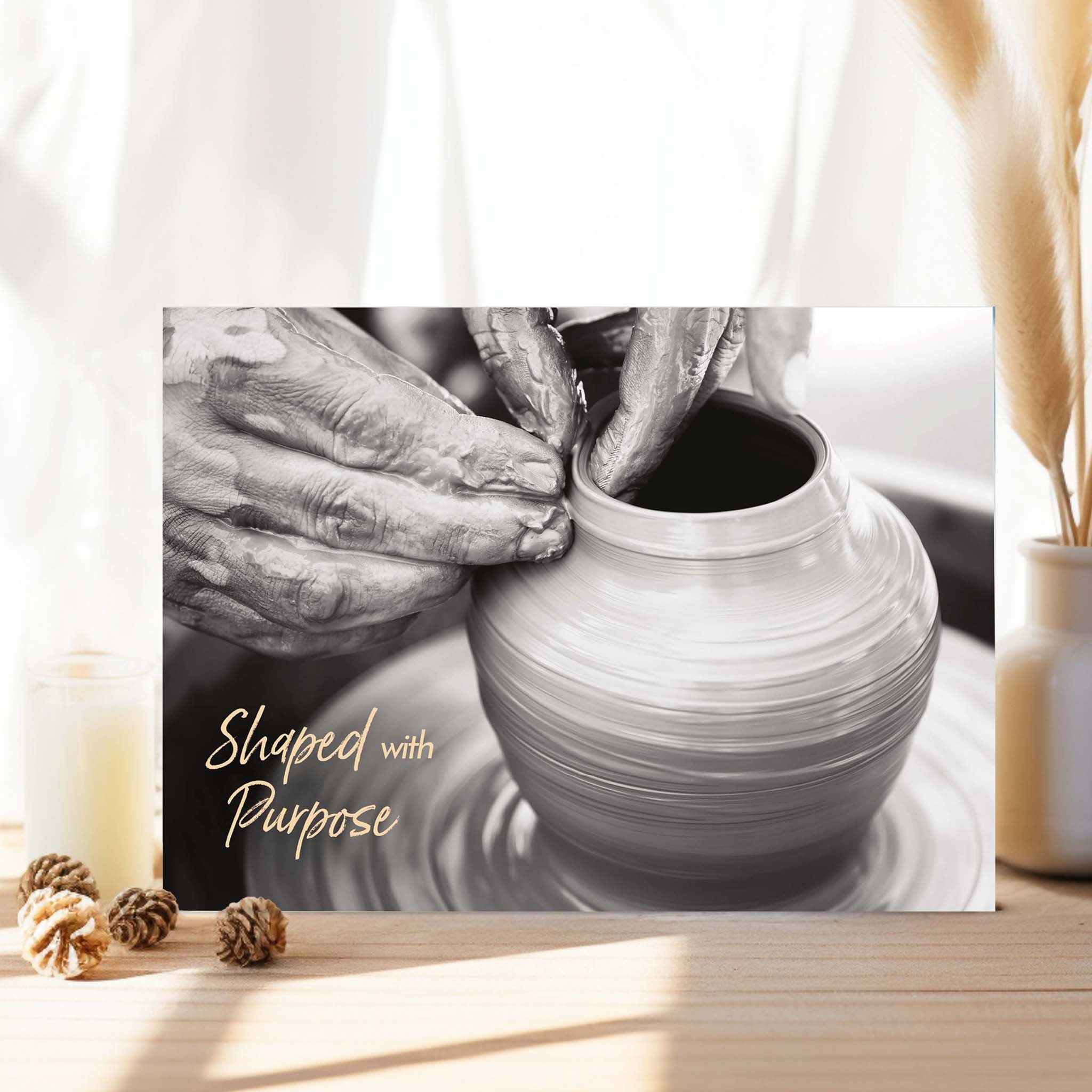 Ceramic potter at work with a pot on a wheel, hands shaping the clay.