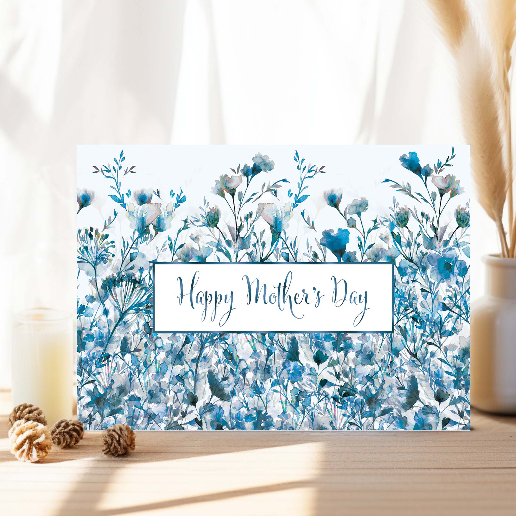 Greeting card with blue floral design and 'Happy Mother's Day' text on a light background.