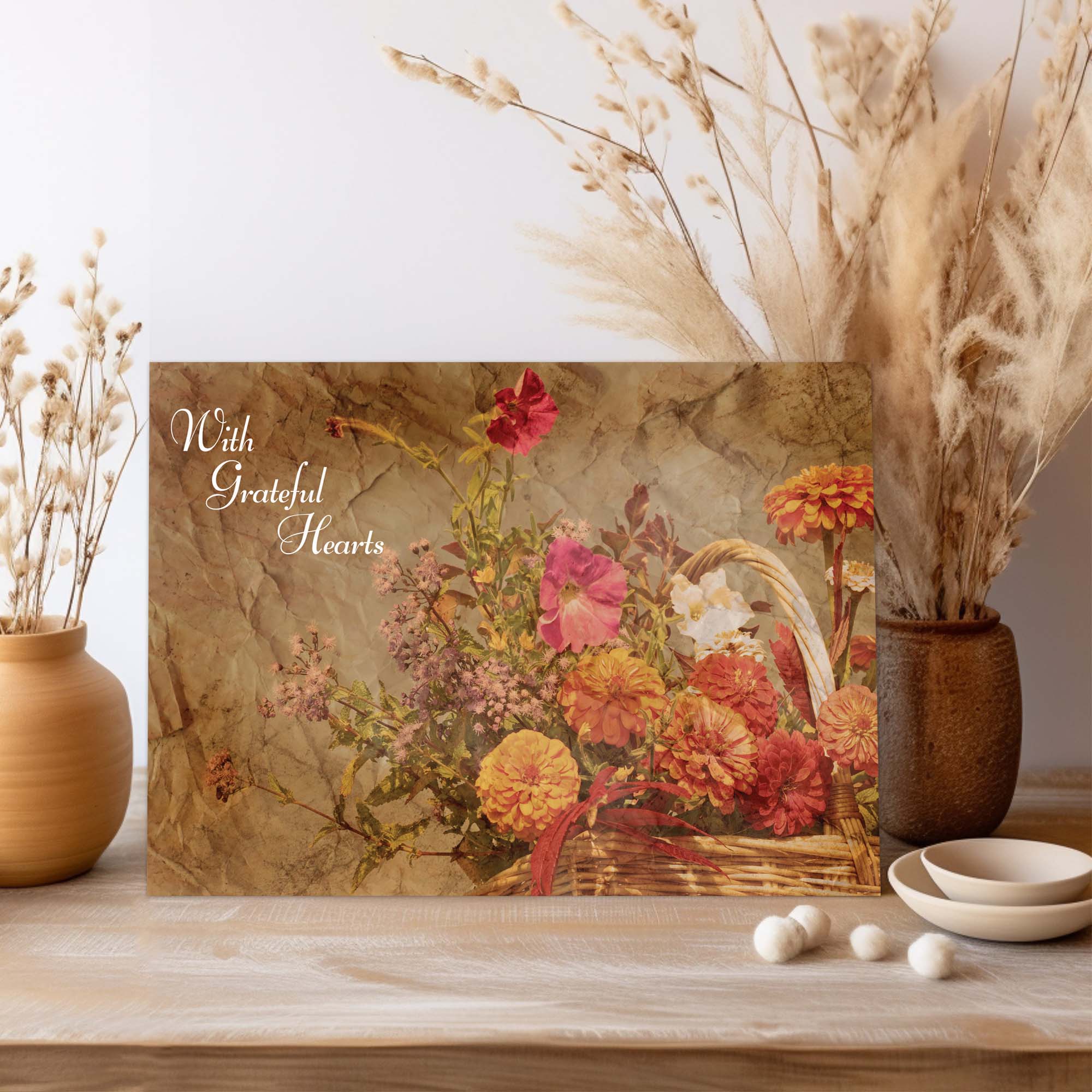 Floral arrangement card with 'With Grateful Hearts' text on a wooden surface with decorative elements.