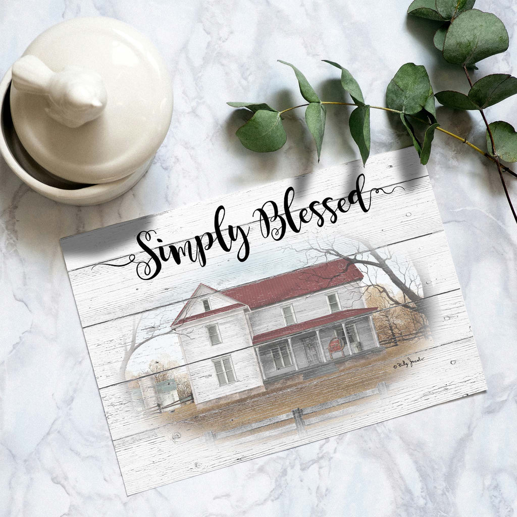 Decorative sign with 'Simply Blessed' text and a house illustration on a marble surface with a white container and greenery.