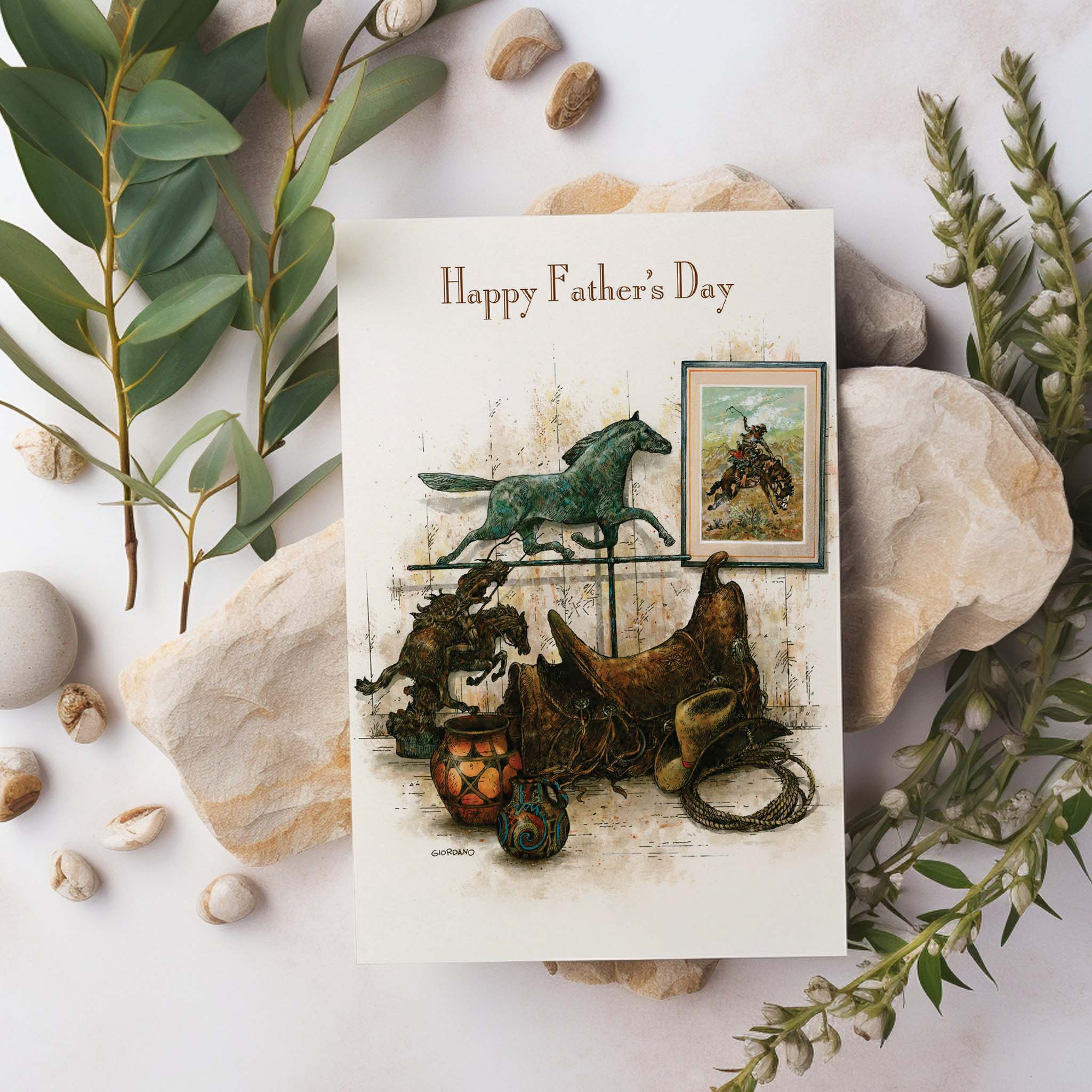 Father's Day card sitting on rocks and greenery