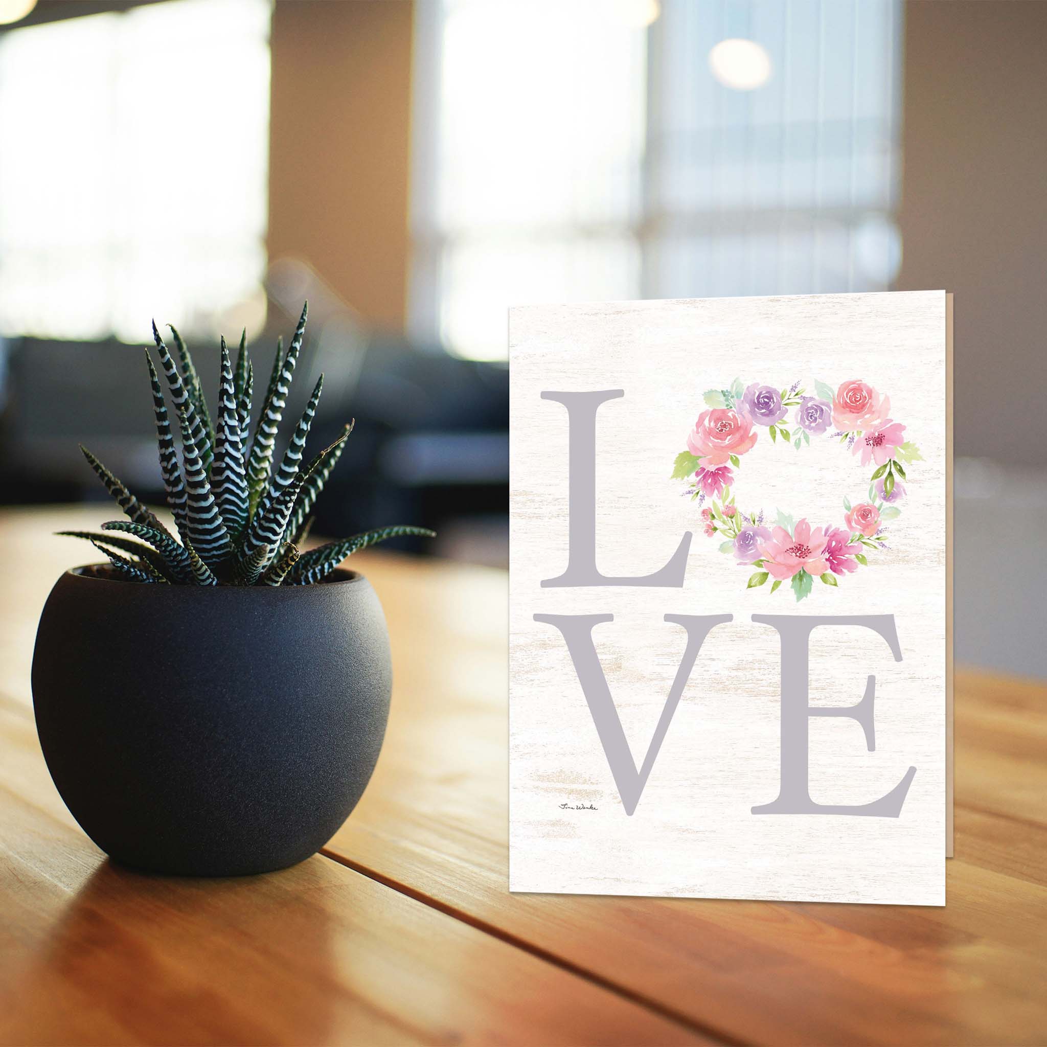 "Love" Valentine Card on Table with Aloe Plant